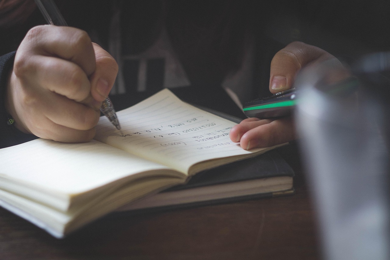 Notebook, hand, pen — Why Slot Online Is Ideal for Casual Gamers
